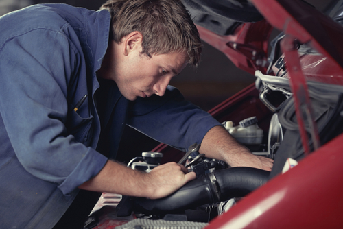 Mechanic servicing a car engine